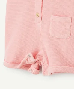 Salopette bébé fille rose en nid d'abeilles avec noeuds