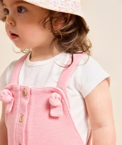 Salopette bébé fille rose en nid d'abeilles avec noeuds