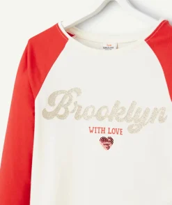 T-shirt fille en coton bio écru et rouge avec message pailleté